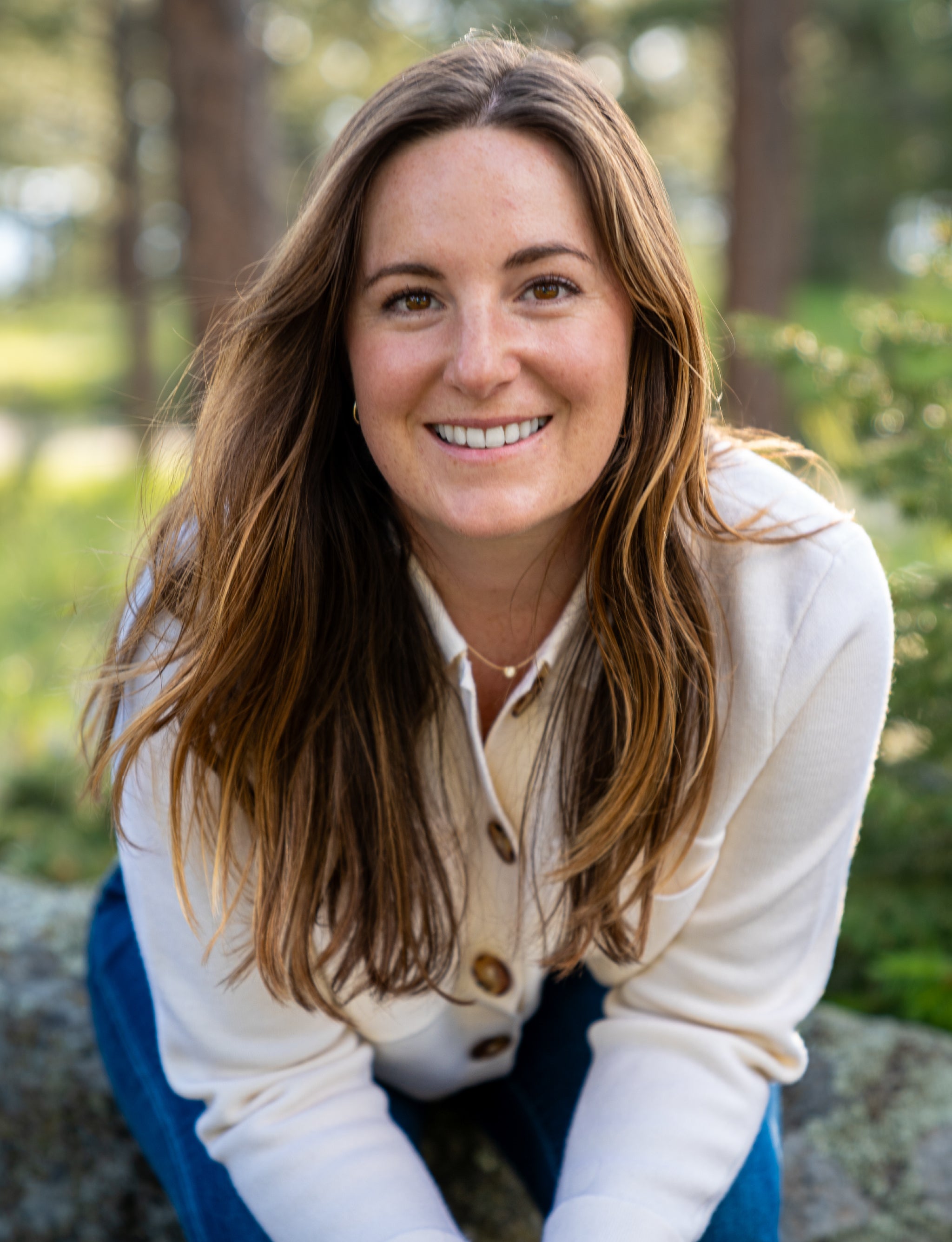 Picture of Emily Cohen, leaning forward and smiling into the camera.