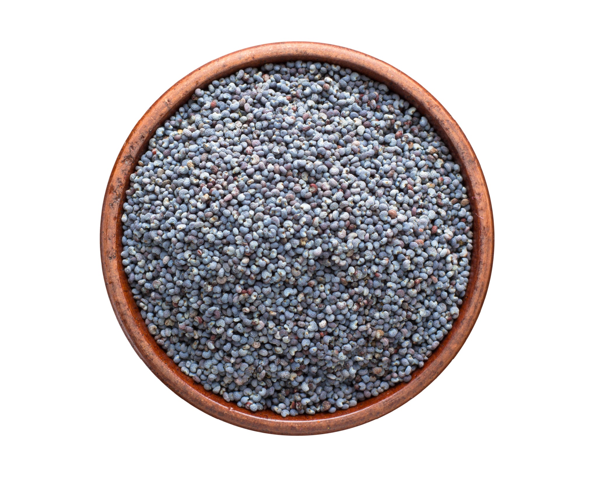 A small wooden bowl filled with poppy seeds, on a white background with seeds scattered around it.