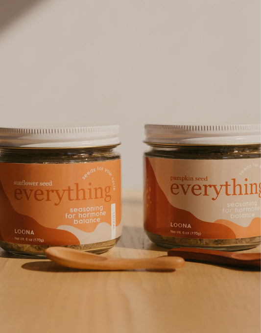 Jars of Loona Seeds' Sunflower Seed blend and Pumpkin Seed blend, sitting on a table.